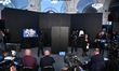 A ceremonial gold helmet and two gold bracelets are displayed during a media presentation...