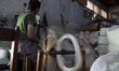 Workers spin yarn inside a textile facility in Kebayoran, South Jakarta, Indonesia, on Apr...