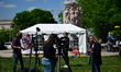 Members of the media and protesters calling for the impeachment of President Donald Trump...