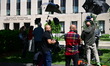 Members of the media and protesters calling for the impeachment of President Donald Trump...