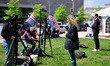 Members of the media and protesters calling for the impeachment of President Donald Trump...