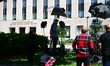 Members of the media and protesters calling for the impeachment of President Donald Trump...