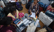 Women election officials check electronic voting machines (EVM) and other polling material...