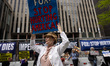 Members and supporters of Rise and Resist and Truth Tuesdays gather for a weekly protest o...