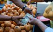 A woman pays for a purchase in U.S. dollars in Caracas, Venezuela, on April 28, 2026. 