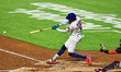 New York Mets player Ronny Mauricio #0 singles during the fourth inning of a baseball game...
