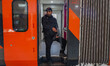 An Indian security personnel stands guard inside a coach of the Vande Bharat passenger tra...