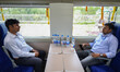 Railway officials sit inside a coach of the Vande Bharat Express train at the Srinagar rai...
