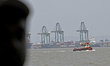 A cargo ship operated by Zhonggu Shipping is docked at a port in Mumbai, India, on April 3...