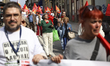 People participate in a protest to mark International Workers' Day, with representation fr...