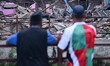 People observe as excavators demolish informal settlements along the Bishnumati River corr...
