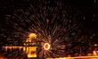 A folk artist performs a fire-themed folk program in Donghu Park, Zaozhuang City, Shandong...
