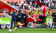 Kyle Walker Peters of West Ham United crosses the ball while under pressure from Kevin Sch...