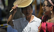 People wear summer clothes as the temperature rises to 35℃ in Harbin,capital of northeast...