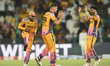 Aaron Hardie (center) of Peshawar Zalmi celebrates a wicket of Hassan Khan with teammate S...