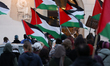 Participants in a pro-Palestinian protest stand in the Main Market Square in Krakow, Polan...
