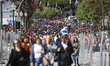 Finalists from Porto's higher education system, wearing different colored top hats and wal...