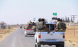 Vehicles and heavy weapons used by Syrian opposition fighters in combat against ISIS in Al...