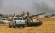 Vehicles and heavy weapons used by Syrian opposition fighters in combat against ISIS in Al...