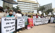 Depositors of non-bank financial institutions hold placards during a silent protest in fro...