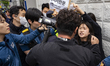 Members of the Korea Alliance of Progressive Students hold placards during a protest in fr...