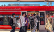 Travelers wait beside a crowded Deutsche Bahn regional train at Munich Central Station in...