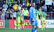 Diego Ribas (center) celebrates a goal scored by Ricardo Quaresma during the Living Legend...