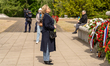 A woman lays flowers at the memorial during Victory Day commemorations at the Soviet Milit...