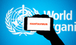 A Hantavirus sign is seen on a smartphone screen, with the World Health Organization (WHO)...