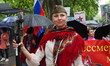 Members of the Russian community in Madrid, Spain, march along Paseo del Prado during the...