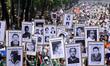 People participate in a Mother's Day demonstration, demanding justice for their missing re...