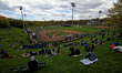 Fans gather on a hillside at Dominico Field at Christie Pits to watch the home opener of t...