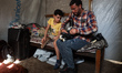 Palestinian amputee skating enthusiast, 13-year-old Akram Sharif Al-Fayoumi, is assisted b...