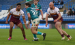 Jamie Shorrocks runs between George King and Taane Milne during the BetFred Super League m...