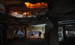 People react to a fire following a reported Israeli military operation on a residential bu...