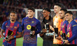 Raphinha Dias, Pau Cubarsi, Lamine Yamal, Joan Garcia, Eric Garcia, and Pedri pose with th...