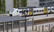 A regional train is seen at Mainz Roemisches Theater station beside Roman theatre ruins in...
