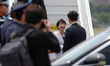 Japanese Prime Minister Sanae Takaichi is greeted by a South Korean Foreign Ministry offic...