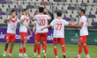 Players of CR Belouizdad react after scoring a goal against MC Oran during the 29th matchd...
