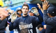 Hudson Valley Renegades player Eric Genther #13 is congratulated in the dugout after scori...