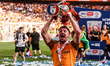 Charlie Hughes of Hull City lifts the Sky Bet Championship Playoff trophy during the Sky B...