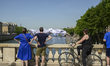 Tourists and onlookers pause to admire the artwork ''The Cave of the Pont Neuf'' in Paris,...