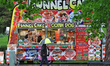 A person walks past a food truck during a rain shower at the Rotary Rib'n'Roll ribfest eve...