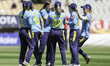 Warwickshire County Cricket Club players celebrate taking the wicket of Rebecca Odgers of...