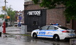 NYPD officers work at the scene where a 29-year-old man is fatally shot in front of 2201 H...
