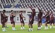 Qatar national team players warm up during the final local training session at Khalifa Int...