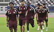 Qatar national team players warm up during the final local training session at Khalifa Int...