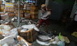 Fish traders, workers, and customers sort and buy fish at Siliguri Regulated Market to dis...