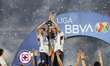 Erik Lira, Gonzalo Piovi #33, and Carlos Rodriguez #19 of Cruz Azul lift the trophy during...