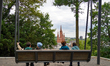 A family sits on a swing overlooking the Market Church in Wiesbaden, Hesse, Germany, on Ma...